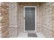 Close-up of the home's front door, showcasing its design and the surrounding brick facade at 1504 Lemon Balm Ct, Lawrenceville, GA 30045