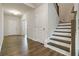 Welcoming hallway with wood floors, stairs, and access to other rooms in the house at 1504 Lemon Balm Ct, Lawrenceville, GA 30045