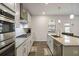 Gourmet kitchen with stainless steel appliances, gas cooktop, and a center island with a sink at 1504 Lemon Balm Ct, Lawrenceville, GA 30045