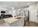 Kitchen boasts a generous island, stainless appliances, and an open flow to the living area at 1504 Lemon Balm Ct, Lawrenceville, GA 30045