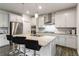 Spacious kitchen island with granite countertop offers casual seating for up to four people at 1504 Lemon Balm Ct, Lawrenceville, GA 30045