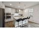Modern kitchen features stainless steel appliances and a large island with bar stool seating at 1504 Lemon Balm Ct, Lawrenceville, GA 30045