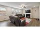 Cozy living room with hardwood floors, a fireplace, and large windows for natural light at 1504 Lemon Balm Ct, Lawrenceville, GA 30045