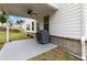 Covered patio area with a ceiling fan, providing a shaded outdoor space next to a well-maintained lawn at 1504 Lemon Balm Ct, Lawrenceville, GA 30045