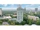 Aerial view showcasing the building, lush landscaping, and cityscape in the background at 2870 Pharr Court South Nw # 1704, Atlanta, GA 30305