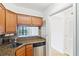 Galley kitchen featuring stainless steel appliances, sink and granite countertops at 2870 Pharr Court South Nw # 1704, Atlanta, GA 30305