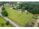 Aerial view showcasing a large lot with lush lawn, fencing, and nearby road at 4067 Mason Creek Rd, Winston, GA 30187