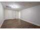 Spacious basement area with wood-look flooring and double door closets for ample storage at 4067 Mason Creek Rd, Winston, GA 30187