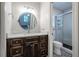Bathroom featuring modern vanity with a marble countertop and a subway tiled walk-in shower at 4067 Mason Creek Rd, Winston, GA 30187