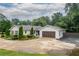 Well-maintained home with a manicured lawn, shrubs, and a three car garage, showcasing curb appeal at 4067 Mason Creek Rd, Winston, GA 30187
