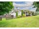 Side view of beautiful home featuring mature trees and well-kept lawn at 4067 Mason Creek Rd, Winston, GA 30187