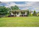 Charming one-story home with manicured lawn, covered porch, and inviting curb appeal at 4067 Mason Creek Rd, Winston, GA 30187