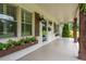 Inviting front porch featuring flower boxes, updated lighting, and wood columns at 4067 Mason Creek Rd, Winston, GA 30187