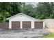Three-car garage with beautiful wood-tone doors providing ample parking and storage at 4067 Mason Creek Rd, Winston, GA 30187