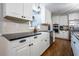 Bright kitchen featuring white cabinets, black countertops, and modern appliances at 4067 Mason Creek Rd, Winston, GA 30187