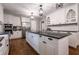 Chic kitchen with white cabinetry, black countertops, and modern lighting at 4067 Mason Creek Rd, Winston, GA 30187