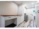 Functional laundry room with workspace, storage cabinets and modern washer/dryer at 4067 Mason Creek Rd, Winston, GA 30187