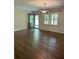 Inviting living room featuring beautiful hardwood floors and a modern light fixture at 4067 Mason Creek Rd, Winston, GA 30187