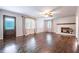 Bright living room featuring hardwood floors, brick fireplace, and neutral decor at 4067 Mason Creek Rd, Winston, GA 30187