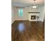 Cozy living room with hardwood floors, fireplace, and modern light fixture at 4067 Mason Creek Rd, Winston, GA 30187