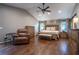Spacious main bedroom featuring vaulted ceilings, hardwood floors, ceiling fan, and a sitting area at 4067 Mason Creek Rd, Winston, GA 30187