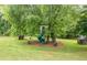 Backyard play area including custom tree house, slide, and playhouse at 4067 Mason Creek Rd, Winston, GA 30187