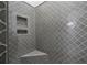 Shower with gray patterned tile, built-in shelves, and corner seat at 4067 Mason Creek Rd, Winston, GA 30187