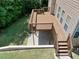 An elevated wood back deck overlooks a yard with shade trees and green grass at 4895 Smokestone Dr, Douglasville, GA 30135