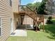A view of a large backyard and wooden deck with stairs leading down to a walkout basement at 4895 Smokestone Dr, Douglasville, GA 30135