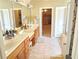 Bathroom features dual sink vanity, linen closet and tile floor at 4895 Smokestone Dr, Douglasville, GA 30135