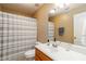 Bathroom with a vanity, toilet, shower, and a striped curtain at 4895 Smokestone Dr, Douglasville, GA 30135