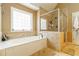 Bright bathroom with soaking tub and tiled walk-in shower at 4895 Smokestone Dr, Douglasville, GA 30135