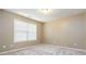 Well-lit carpeted bedroom featuring a large window providing ample natural light at 4895 Smokestone Dr, Douglasville, GA 30135