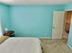 Bright blue bedroom with large neutral carpet and simple bedside decor at 4895 Smokestone Dr, Douglasville, GA 30135