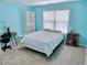 Bright blue bedroom with a neutral carpet, window, bookshelf, and desk at 4895 Smokestone Dr, Douglasville, GA 30135