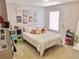 Cozy bedroom featuring a window, comfortable bed, and decorative wall art at 4895 Smokestone Dr, Douglasville, GA 30135
