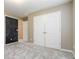 Carpeted bedroom with neutral walls, double doors, and an adjoining room at 4895 Smokestone Dr, Douglasville, GA 30135