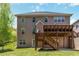 Back exterior showing a large yard with a wooden deck and patio at 4895 Smokestone Dr, Douglasville, GA 30135
