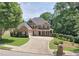 Beautiful two-story brick home featuring a well-manicured lawn, attached garage, and a cozy covered front porch at 4895 Smokestone Dr, Douglasville, GA 30135