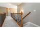 Upstairs hallway features decorative railing, neutral paint and plush carpet at 4895 Smokestone Dr, Douglasville, GA 30135