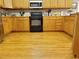 Traditional kitchen featuring wood cabinets, hardwood floors, and modern appliances at 4895 Smokestone Dr, Douglasville, GA 30135
