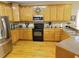 Kitchen features wood cabinets, black appliances, and great lighting at 4895 Smokestone Dr, Douglasville, GA 30135