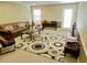 Inviting living room with a comfortable brown couch and unique circle rug at 4895 Smokestone Dr, Douglasville, GA 30135