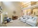 Spacious living room with fireplace, soaring ceilings, plush seating, and staircase at 4895 Smokestone Dr, Douglasville, GA 30135