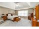 Relaxing main bedroom with tray ceiling, plush carpet and bright window at 4895 Smokestone Dr, Douglasville, GA 30135