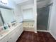 Well-appointed bathroom with a soaking tub, a separate shower, and double sink vanities for added convenience at 1630 Versailles Dr, Atlanta, GA 30331