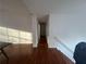 Bright hallway with wood flooring leading to various rooms and stairs at 1630 Versailles Dr, Atlanta, GA 30331
