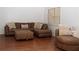 Comfortable living room with a large brown sectional sofa and a round chair at 1630 Versailles Dr, Atlanta, GA 30331