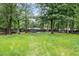 Expansive backyard with mature trees, creating a private and inviting outdoor space for leisure and activities at 1634 Crittenden Ln, Lawrenceville, GA 30043