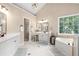 Bright bathroom with double vanities, a soaking tub, and a separate makeup area at 1634 Crittenden Ln, Lawrenceville, GA 30043